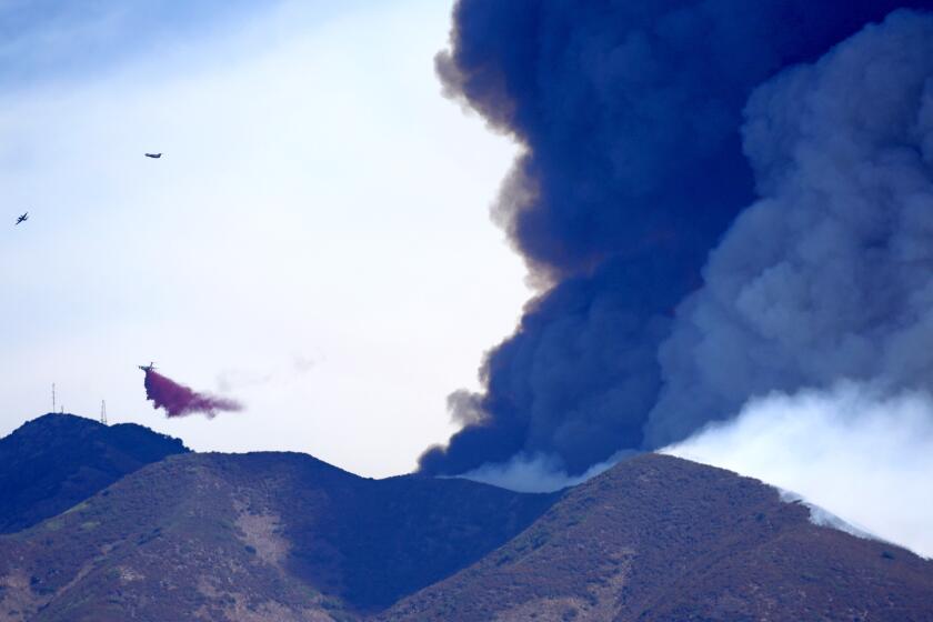 TRABUCO CANYON CALIF SEPTEMBER 10, 2024 - Firefighting aircraft battle the Airport fire, dropping retardant near Santiago Peak on Tuesday, Sept. 10, 2024. The Airport fire has charred more than 9,000 acres. (Allen J. Schaben / Los Angeles Times)