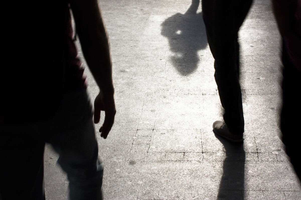 Shadows and silhouettes of people on a street