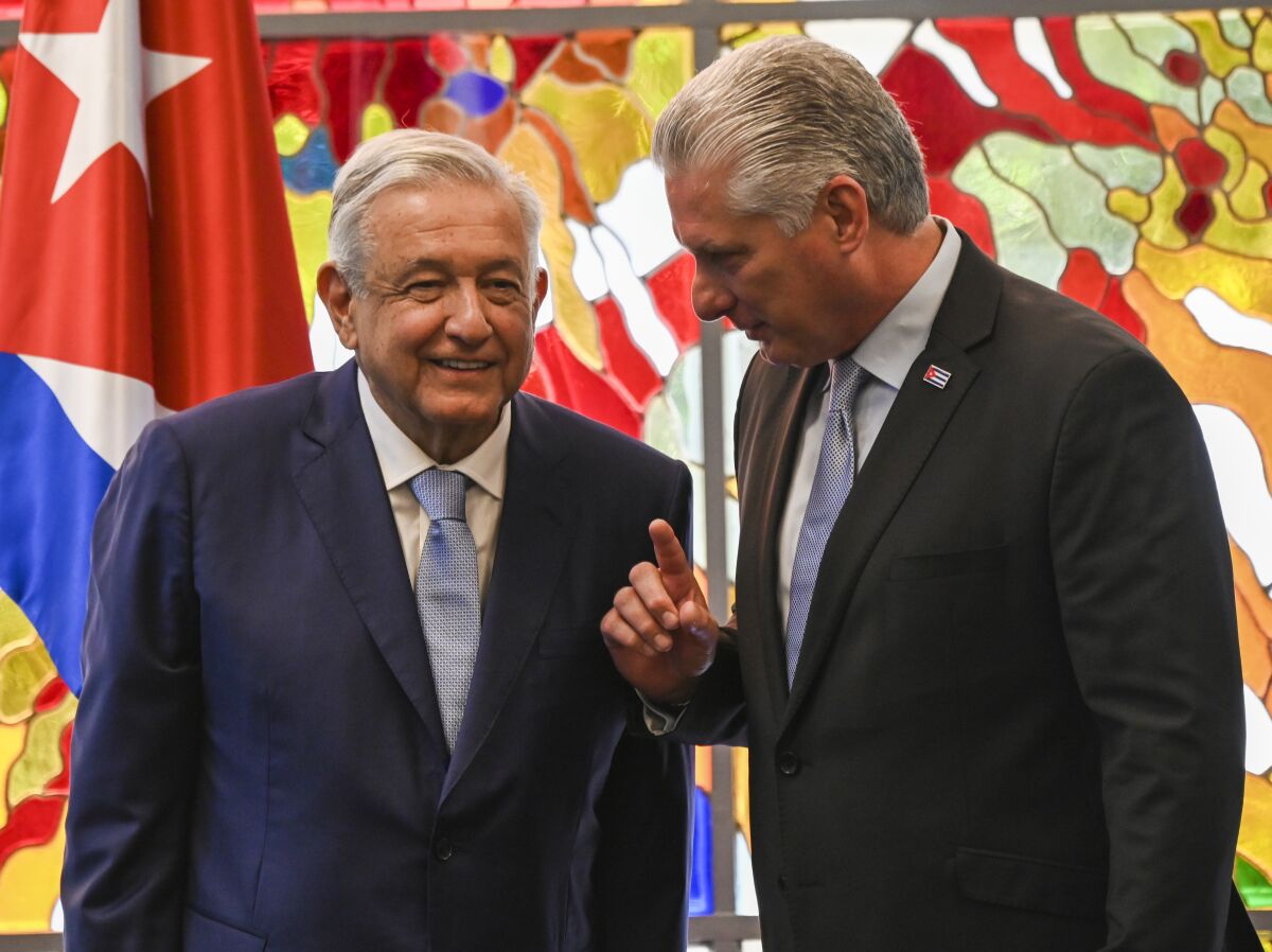 Cuban president Miguel Diaz Canel and his Mexican counterpart Andrés Manuel López Obrador chat after signing bilateral agreements at Revolution Palace in Havana, Cuba, Sunday, May 8, 2022. (Yamil Lage/Pool Photo via AP)