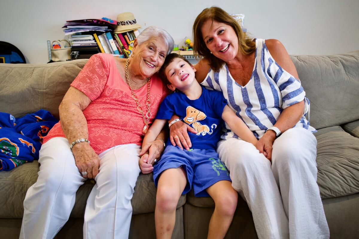 John Rodriguez, 6, with his great-grandmother Elena Chavez and his grandmother Elena Blasser on a couch. 