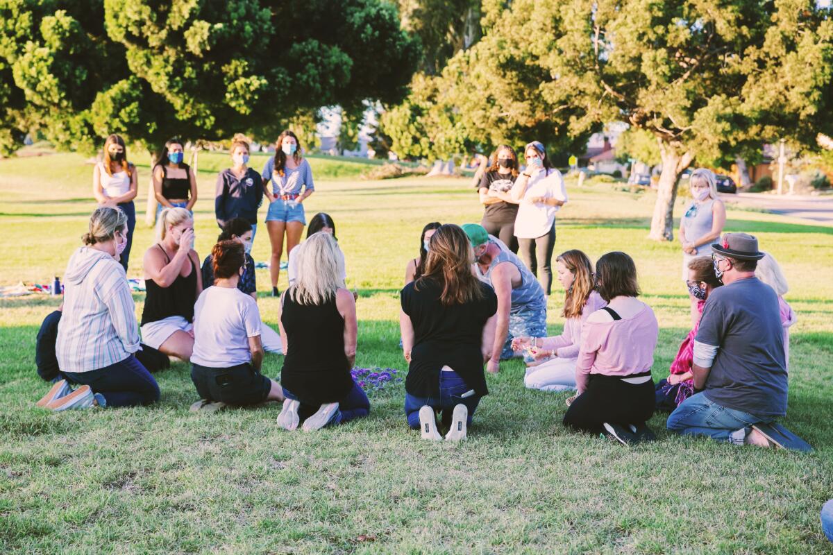 Local residents gathered around a mandala in recognition of International Overdose Awareness Day.