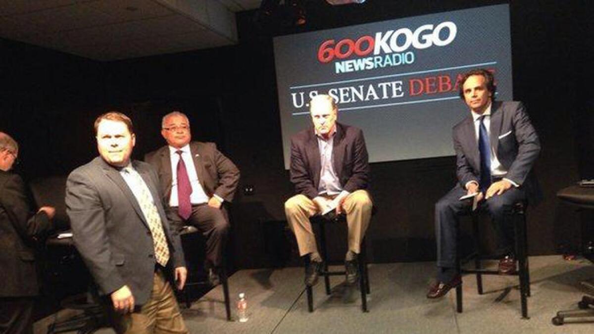 Rocky Chavez, seated left, with George "Duf" Sundheim, middle, and Tom Del Beccaro, right, at a debate Monday night.