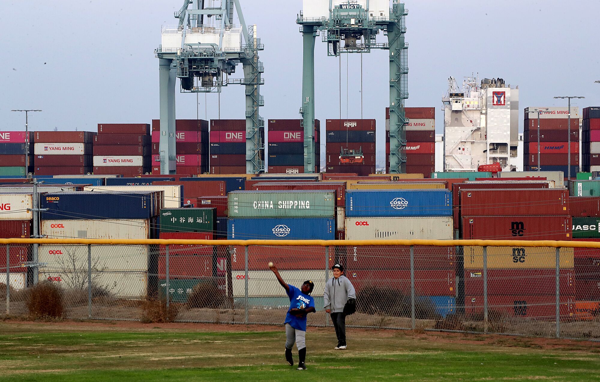 Kids play on a Little League baseball field that overlooks the Port of Los Angeles in San Pedro.