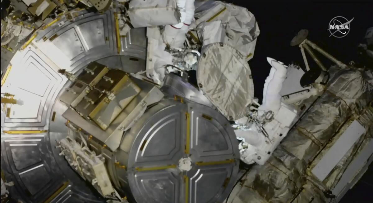 Two astronauts out on a spacewalk at the International Space Station