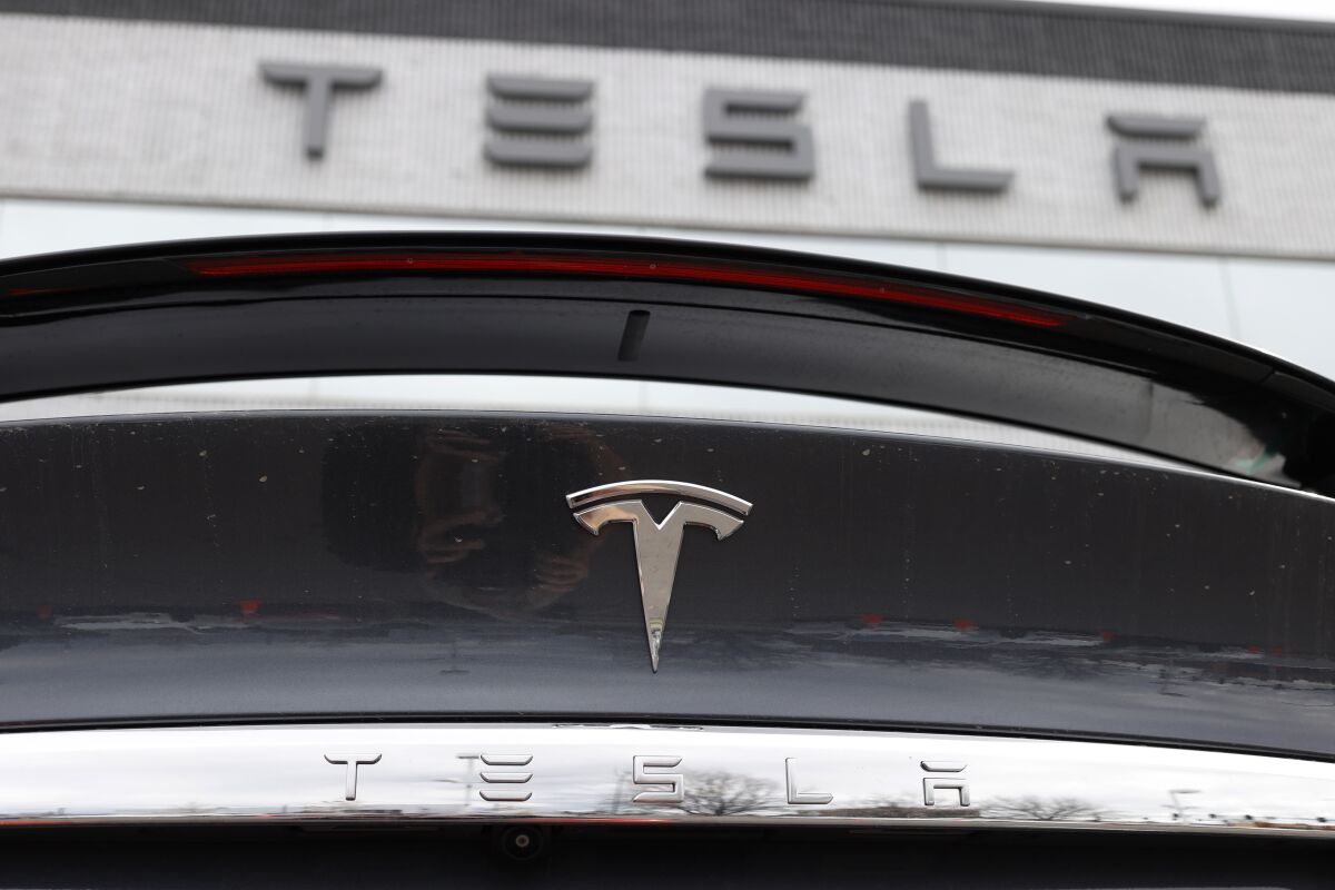 A closeup of the Tesla logo on the rear deck a 2020 Model X