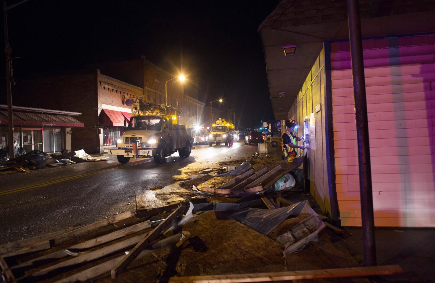 Utility trucks make their way down West Main Street in Waverly, Va., after it was hit by a tornado Feb. 24, 2016.