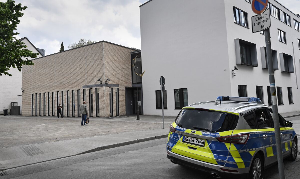 A police car stands in front of the synagogue in Gelsenkirchen, Germany, Thursday, May 13, 2021. Germany's leading Jewish group has sharply condemned protests in front of a synagogue in the western city of Gelsenkirchen as "pure antisemitism." The Central Council of Jews in Germany on Thursday tweeted a video of dozens of protesters waving Palestinian and Turkish flags and yelling expletives about Jews. (AP Photo/Martin Meissner)