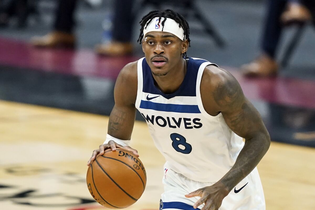 FILE- In this Feb. 1, 2021, file photo, Minnesota Timberwolves' Jarred Vanderbilt drives against the Cleveland Cavaliers in the second half of an NBA basketball game, Monday,, in Cleveland. The Timberwolves have filled out their roster by re-signing Vanderbilt. (AP Photo/Tony Dejak, File)