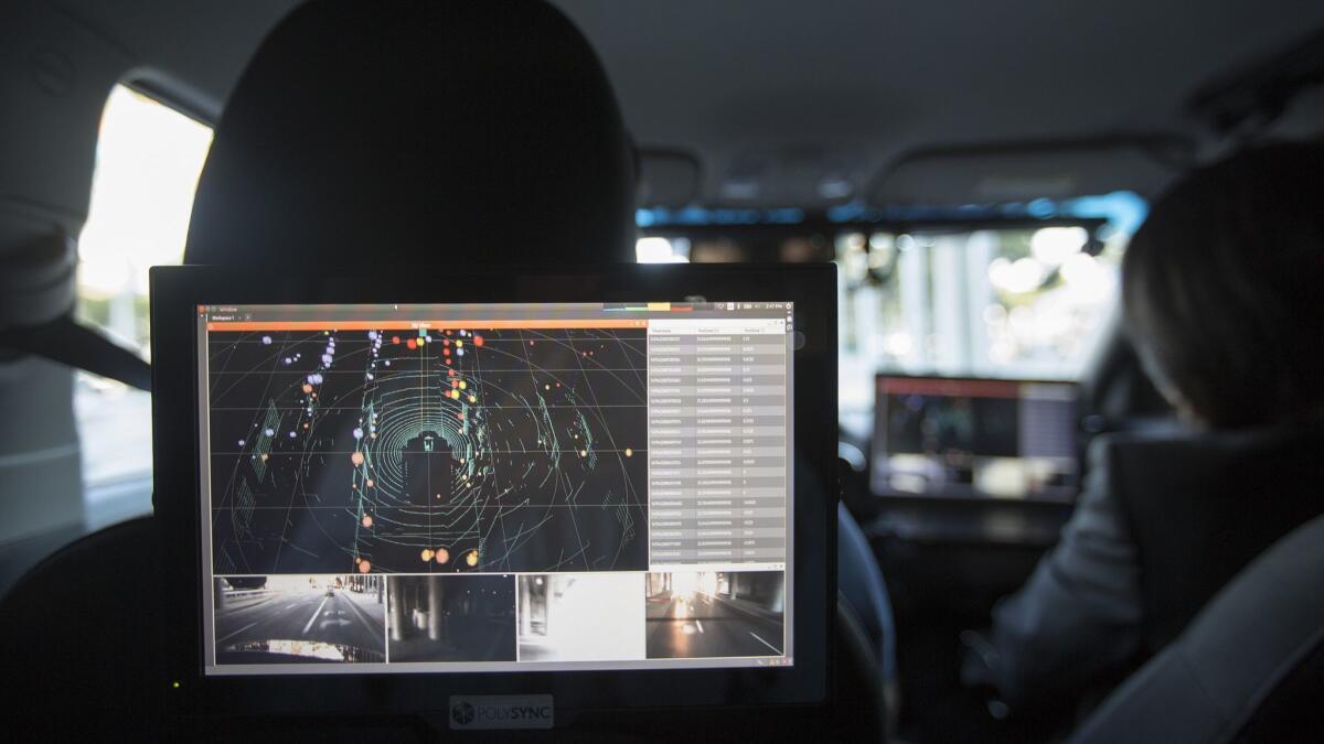 Data from lidar, radar, cameras and GPS units are displayed inside a car equipped with a PolySync driverless-technology monitoring system during the AutoMobility LA trade show at the Los Angeles Convention Center in 2016.