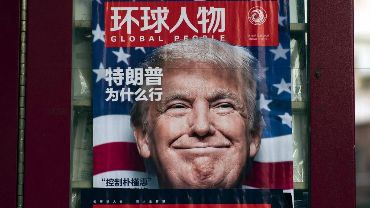 A newsstand in Shanghai, China, bears an ad for a magazine featuring Donald Trump on the cover.