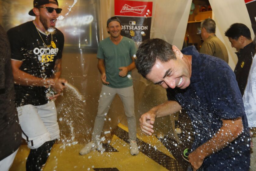 SAN DIEGO, CA - OCTOBER 2: San Diego Padres pitcher Joe Musgrove drenches A.J. Preller in the locker room after the team clinched a wildcard playoff spot at Petco Park on Sunday, October 2, 2022 in San Diego, CA. (K.C. Alfred / The San Diego Union-Tribune)