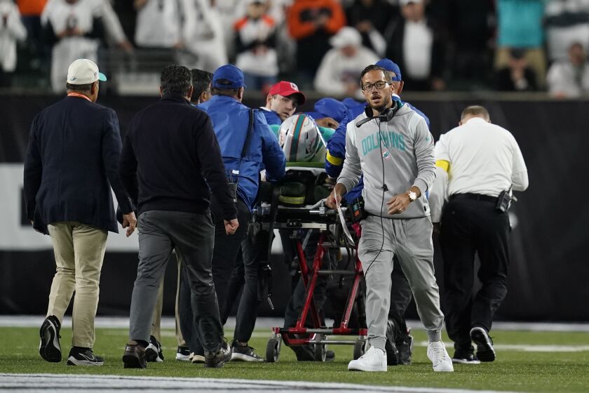 Miami Dolphins head coach Mike McDaniel walks away as quarterback Tua Tagovailoa is taken off the field on a stretcher during the first half of an NFL football game against the Cincinnati Bengals, Thursday, Sept. 29, 2022, in Cincinnati. (AP Photo/Joshua A. Bickel)