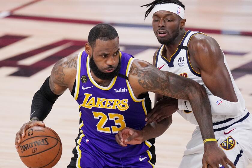 Los Angeles Lakers' LeBron James (23) drives against Denver Nuggets' Jerami Grant.