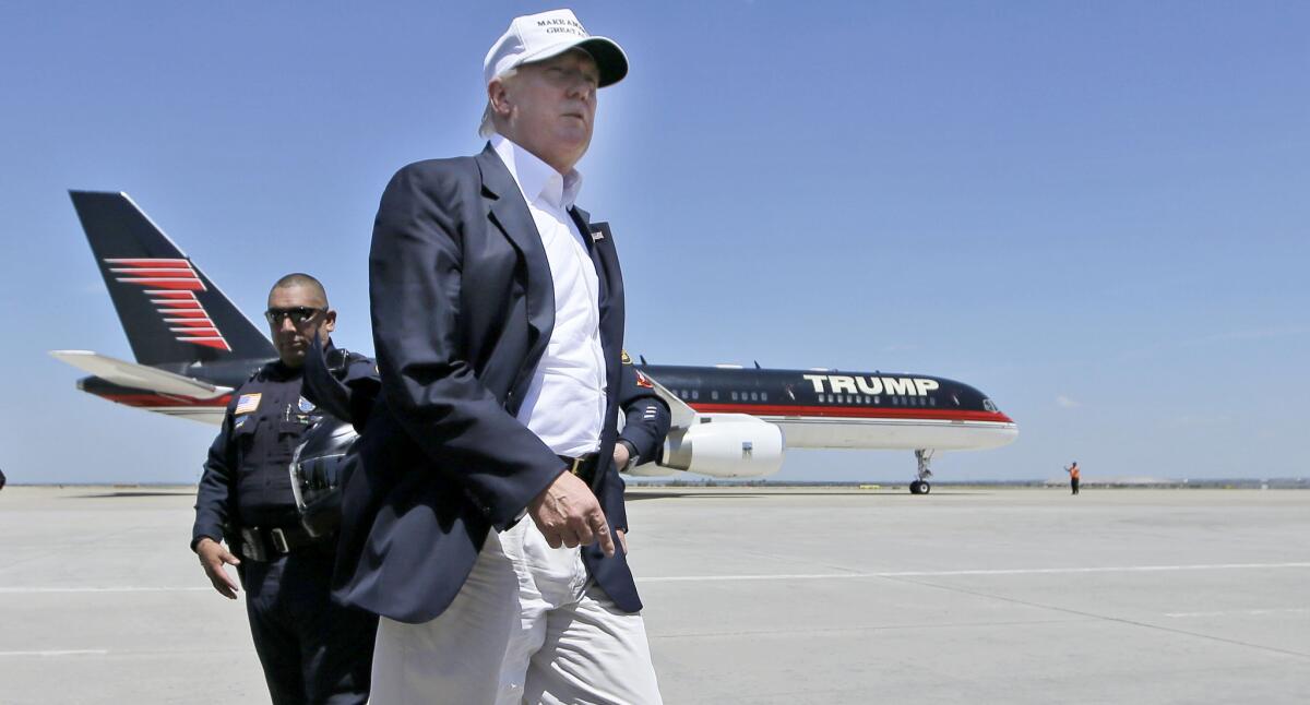 Republican presidential hopeful Donald Trump walks the tarmac before boarding his campaign plane to depart from Laredo, Texas, Thursday, July 23, 2015. (AP Photo/LM Otero)