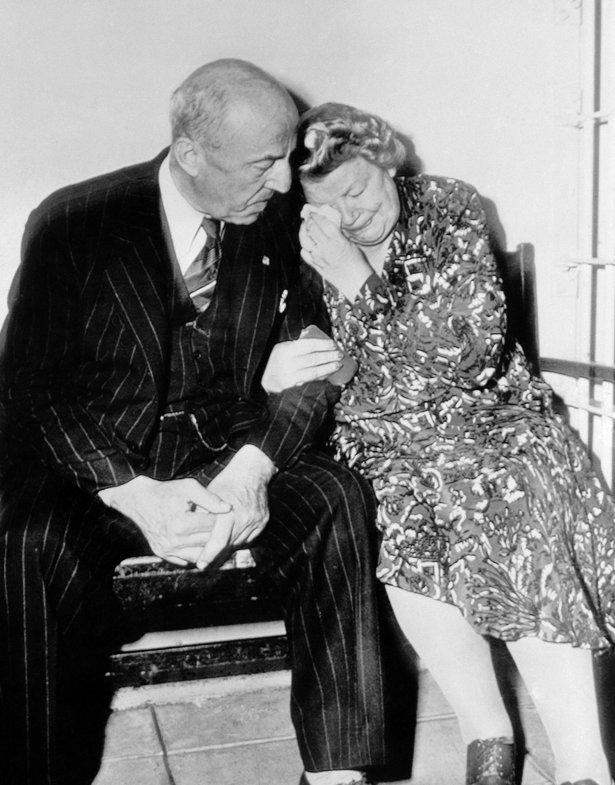 Elizabeth Ingalls leans on her husband's shoulder and weeps.