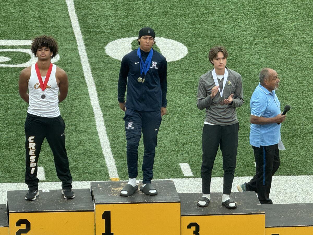 Darren Haggerty of Viewpoint gets honored on the victory stand after winning the Division 4 long jump.