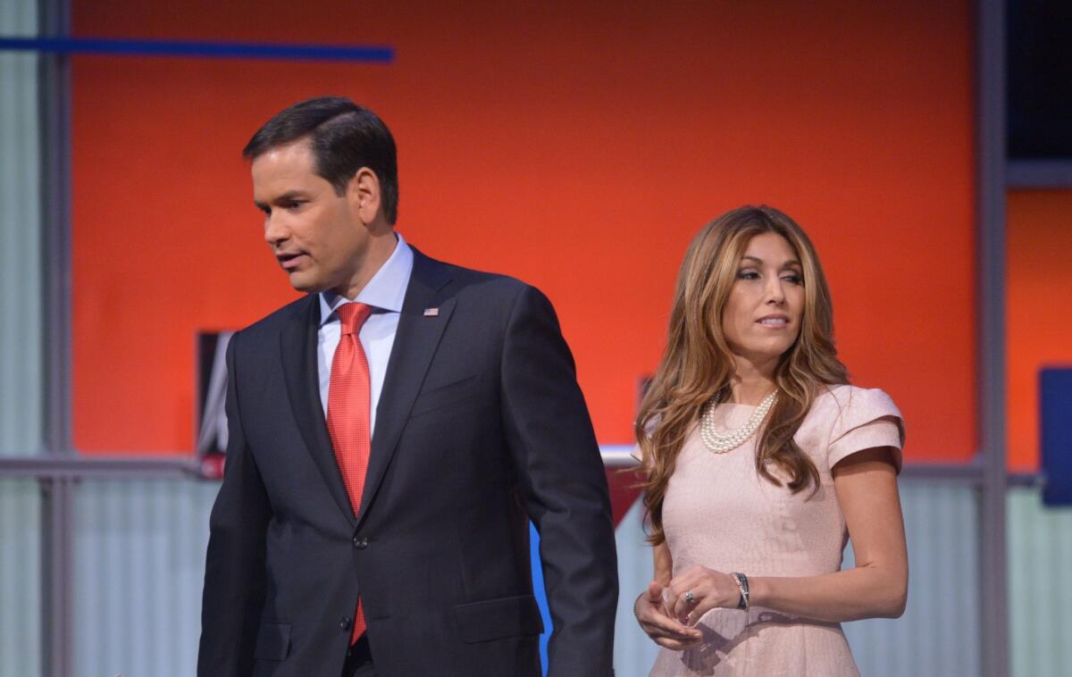 Florida Sen. Marco Rubio stands with his wife, Jeanette Dousdebes, following the Republican presidential primary debate in Cleveland.
