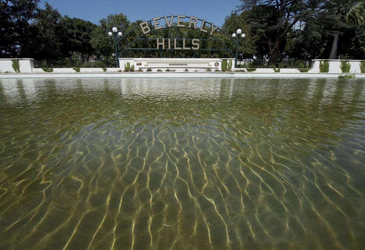 The Beverly Hills lily pond with the city's famous sign is seen on April 9. On average wealthier neighborhoods like Beverly Hills consume more water than less affluent ones, according to a study by researchers at UCLA.