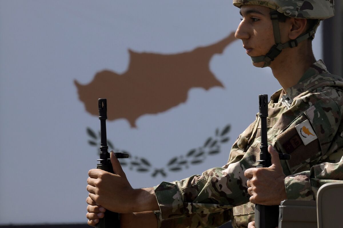 A Cypriot soldier sits on a truck during a military parade marking the 62nd anniversary of Cyprus' independence from British colonial rule, in Nicosia, Cyprus, Saturday, Oct. 1, 2022. Cyprus gained independence from Britain in 1960 but was split along ethnic lines 14 years later when Turkey invaded following a coup aimed at uniting the island with Greece. (AP Photo/Petros Karadjias)