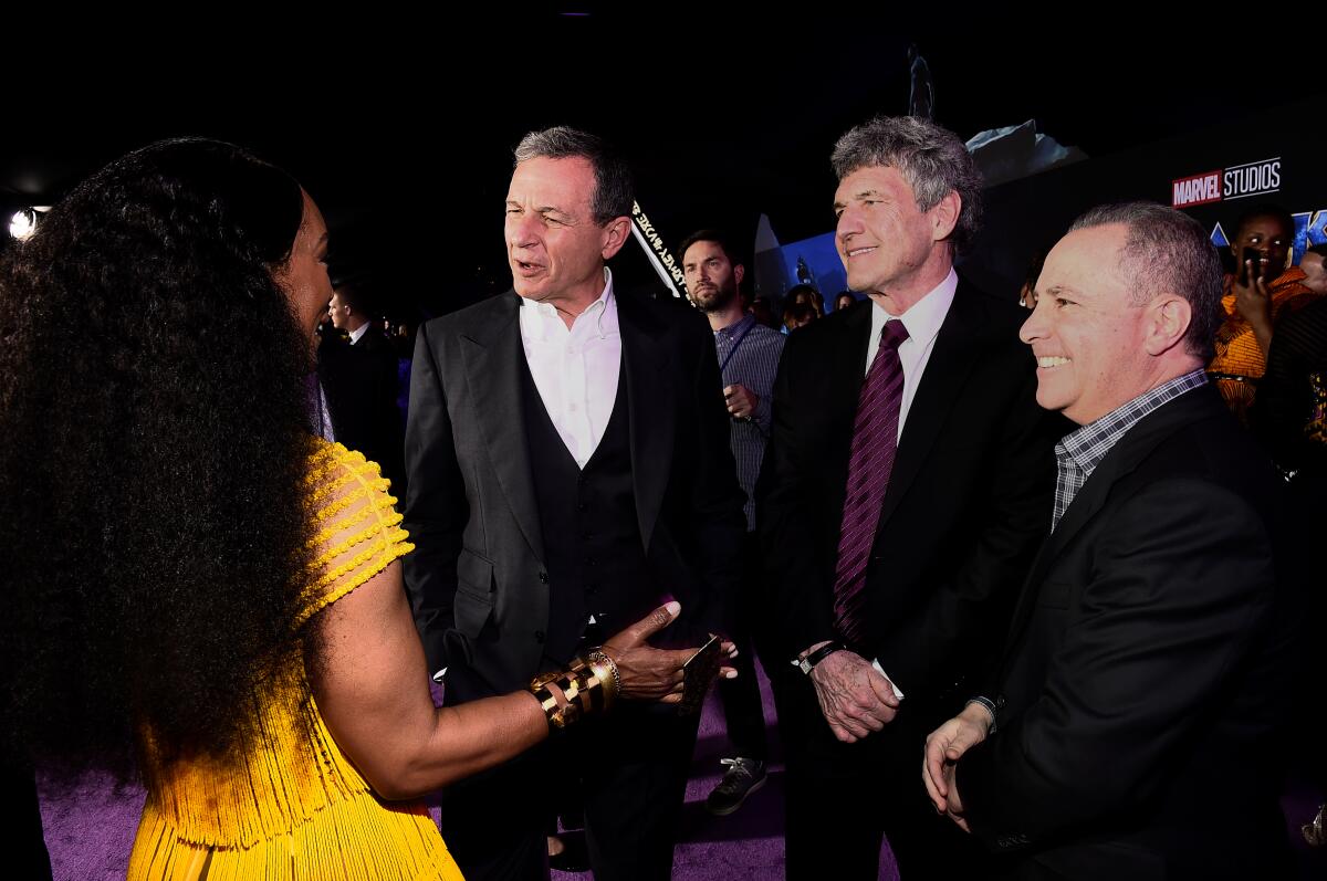 Bob Iger and other executives talk with Angela Bassett.