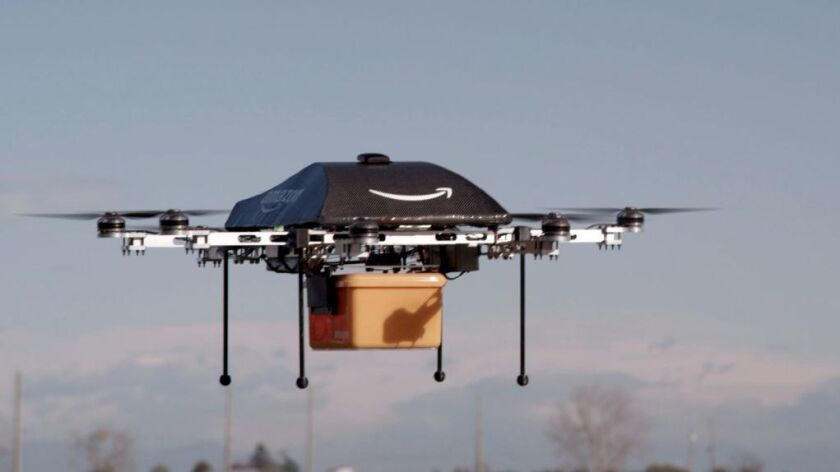 This undated handout photo released by Amazon shows a flying "octocopter" mini-drone that would be used to fly small packages to consumers. Amazon said Dec. 14, 2016 it completed its first delivery by drone.