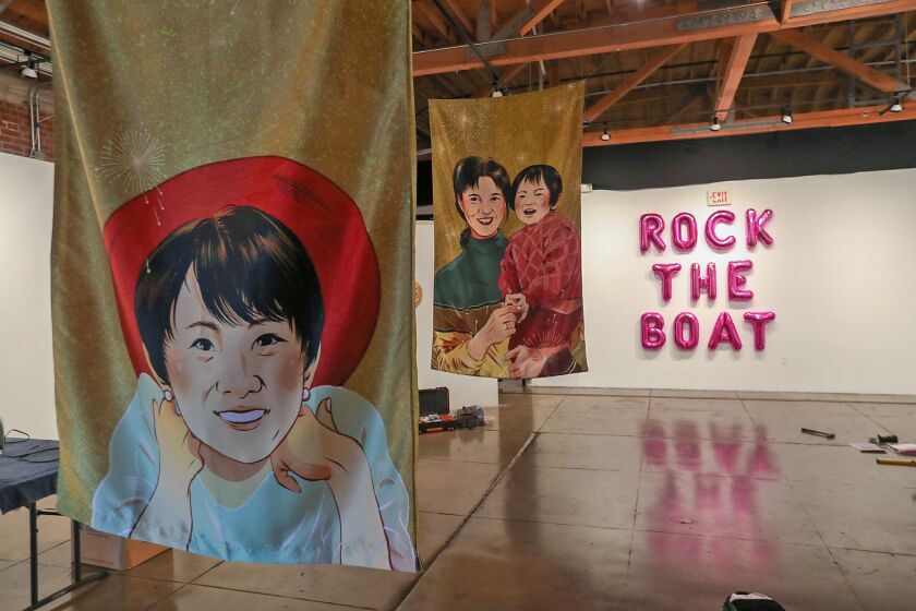 Hand painted banners of family at the YELLOW SUBMARINE RISING: Currents within Asian American Art show at the Orange County Center for Contemporary Art in Santa Ana. The show is a multidisciplinary art exhibition showcasing compelling work by asian-americas artists inspired by #stopasianhate movement, and opens on Saturday, December 3, 2022.