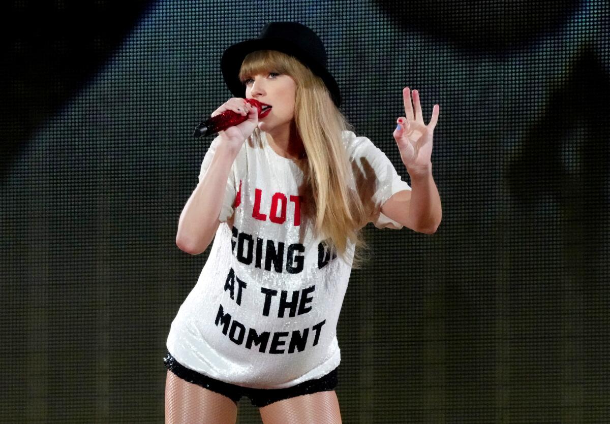 Taylor Swift wearing a T-shirt that says, "A lot going on at the moment."