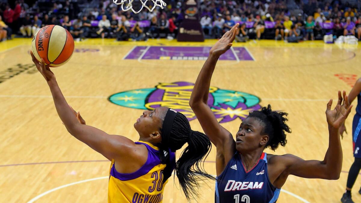 Sparks forward Nneka Ogwumike attempts a reverse layup against the defense of Dream forward Aneika Henry-Morello during the first half Friday.