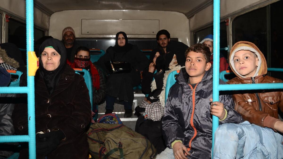 Syrian families from various eastern districts of Aleppo are evacuated by bus on Nov. 27, 2016, as Syrian government forces continue their advance toward rebel-controlled districts.