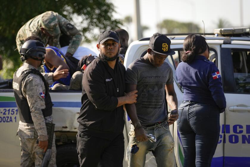 Migration officials detain undocumented Haitians in Santo Domingo, Dominican Republic, Thursday, May 16, 2024. As soaring violence and political turmoil grip neighboring Haiti, Dominican Republic’s election on May 19 has been defined by calls for more migratory crackdowns and finishing a border wall dividing the countries. (AP Photo/Matias Delacroix)