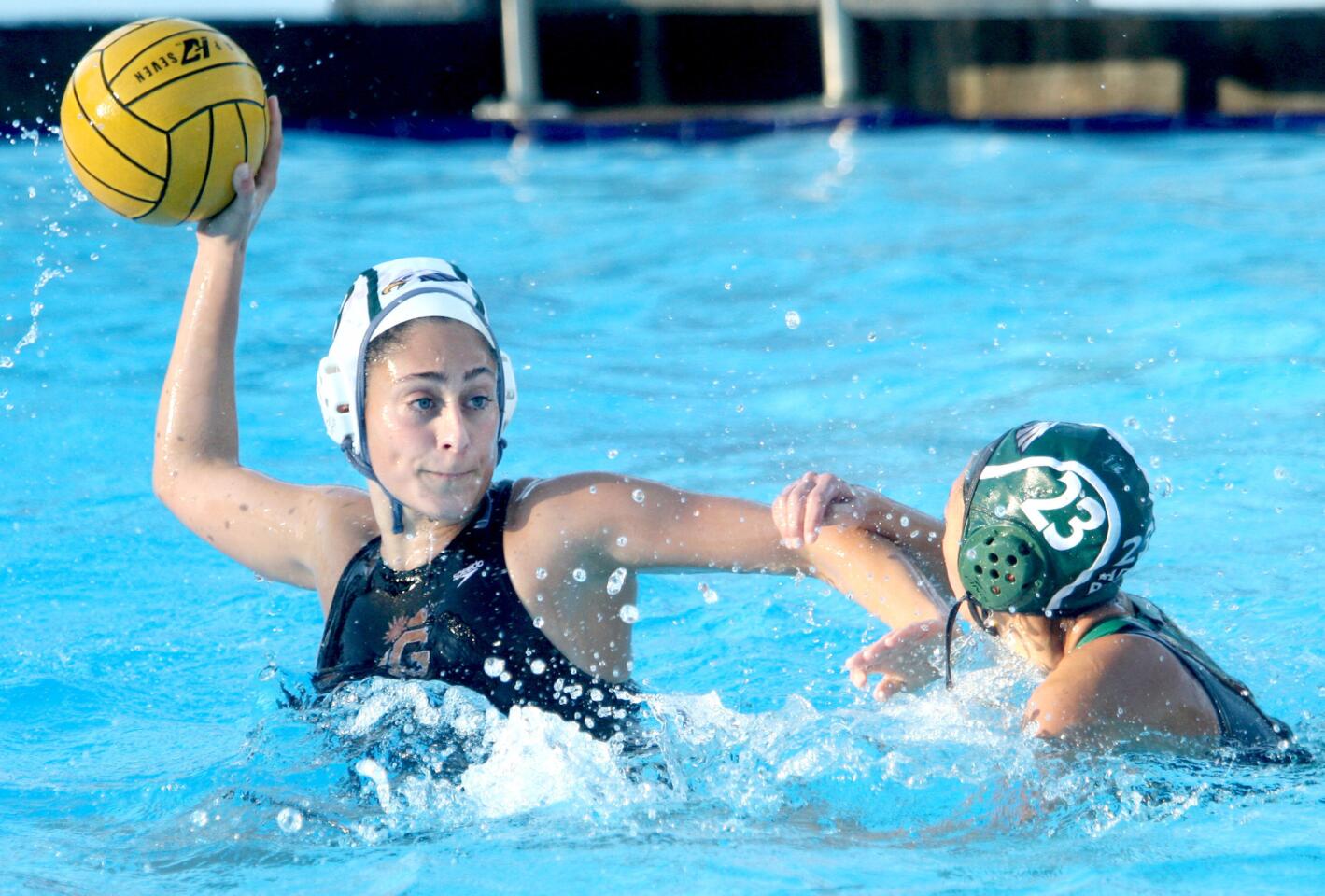Glendale High School girls water polo player #9 Lori Berberian, left, looks to shoot with pressure from #23 Lian Utsumi in away game at Eagle Rock High School in Eagle Rock on Tuesday, December 1, 2015.