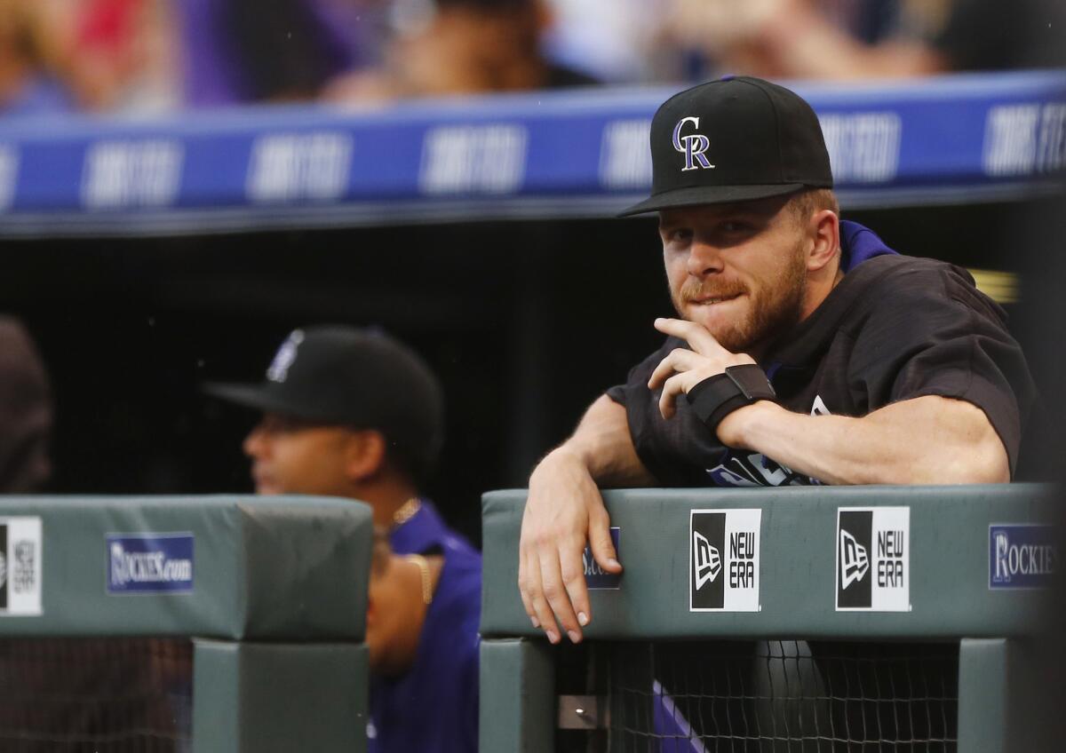 Rockies shortstop Trevor Story looks on from the dugout during the first inning against the Dodgers after going on the disabled list with a torn thumb ligament.
