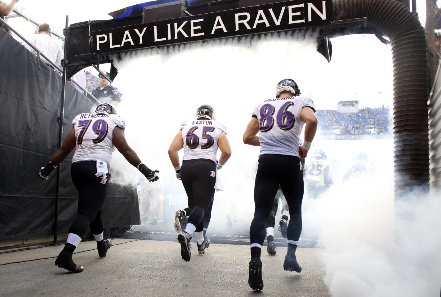Ravens defensive tackle Micajah Reynolds (#79), defensive tackle Nick Easton (#65), and tight end Konrad Reuland (#86) run out to the field before a preseason exhibition game between the Ravens and New Orleans Saints at M&T Bank Stadium.