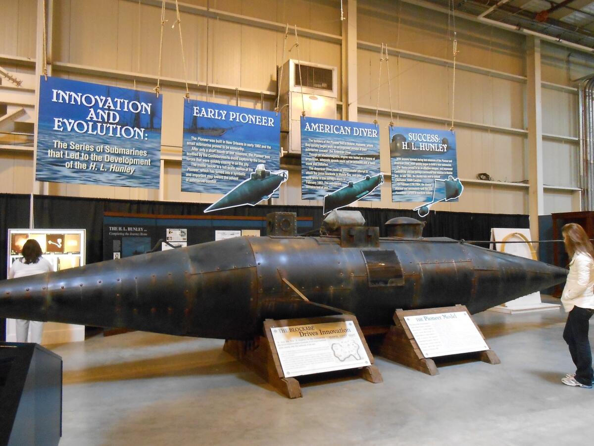 A full-scale model of the 34-foot Pioneer, the first prototype that led to the development of the Hunley submarine, is part of a suite of exhibits on display in Charleston.