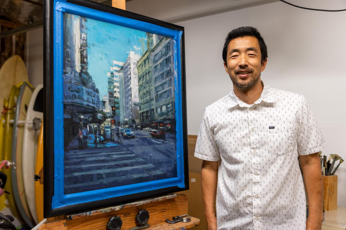 Artist Pil Ho Lee stands by his oil painting titled "Diamond Theater" at his home in Orange on Wednesday.