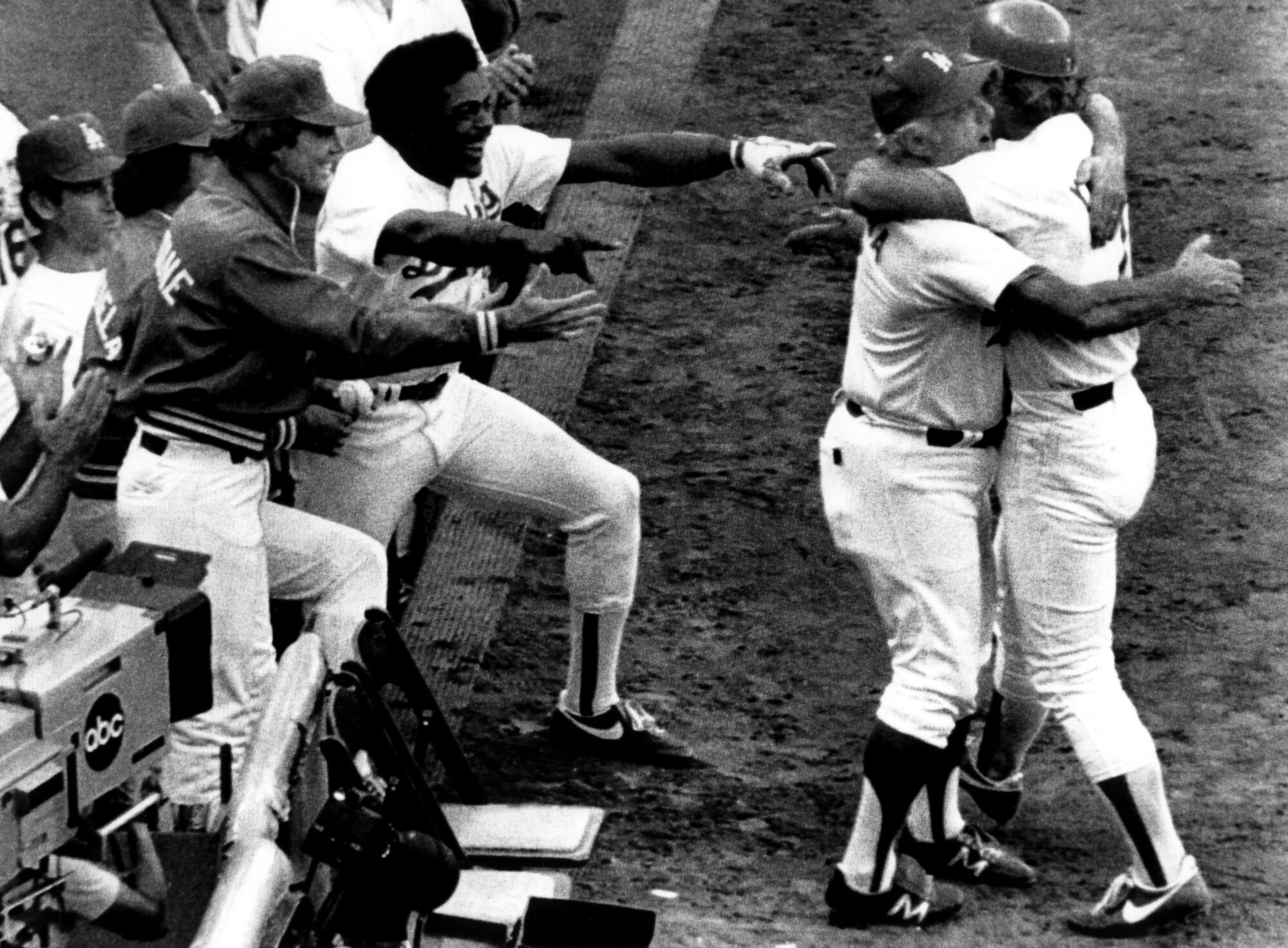 Tommy Lasorda hugs Steve Yeager after Yeager hit a home run in Game 5 of the 1981 World Series against the New York Yankees