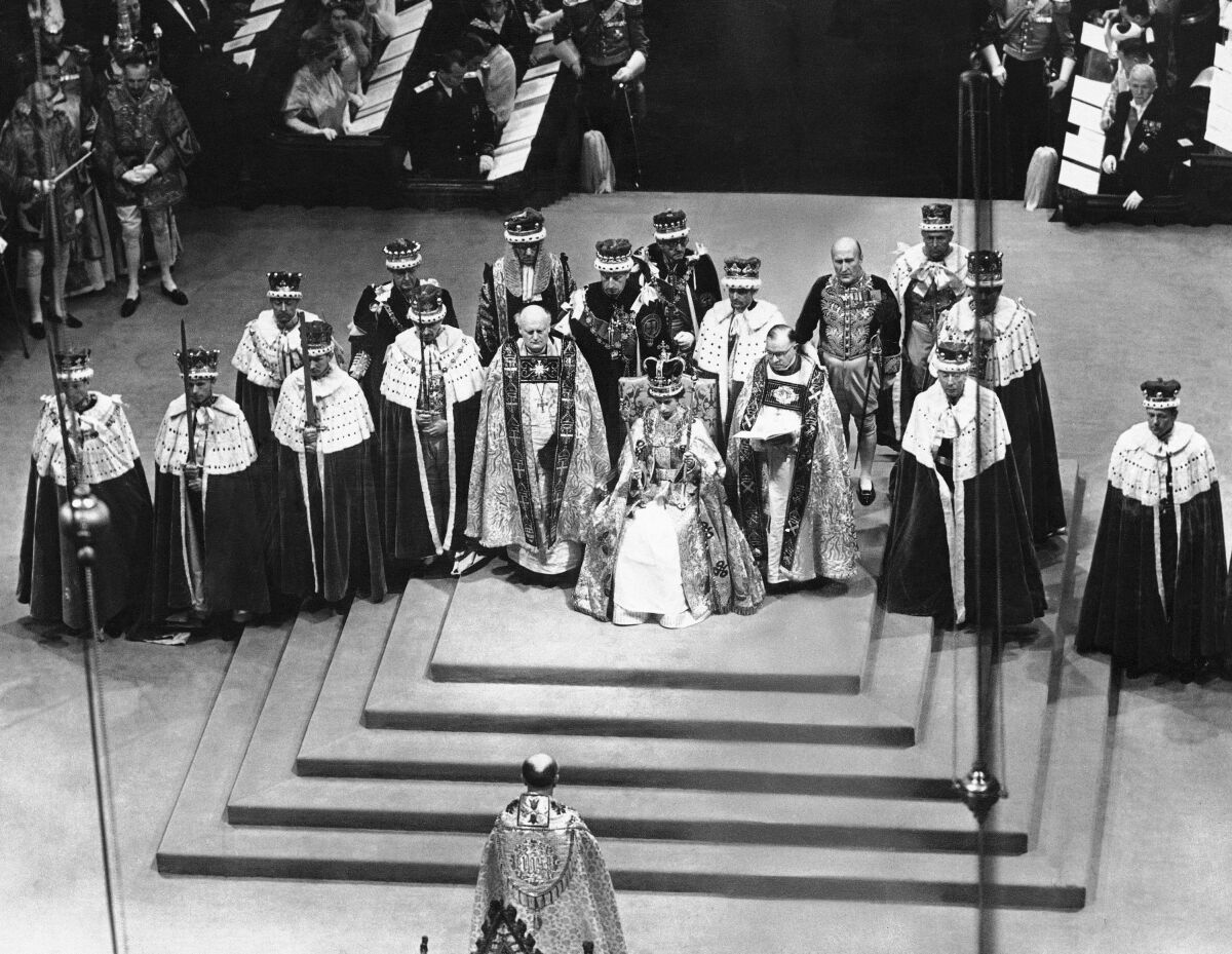 FILE - Surrounded by peers and churchmen, Queen Elizabeth II sits on throne in Westminister Abbey, London, June 2, 1953 after her coronation. Britain is marking Queen Elizabeth II's Platinum Jubilee on Sunday, Feb. 6, 2022, 70 years after she ascended to the throne. (AP Photo, File)