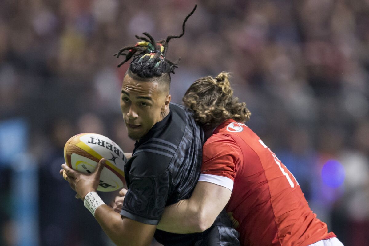 FILE - In this Nov. 3, 2017, file photo, Maori All Blacks' Sean Wainui, left, is hit by Canada's Dan Moor during the first half of a rugby match in Vancouver, British Columbia. Sean Wainui, a rising star of Super Rugby with the Hamilton-based Chiefs, died Monday, Oct. 18, 2021 in an auto accident. He was 25. (Darryl Dyck/The Canadian Press via AP, File)