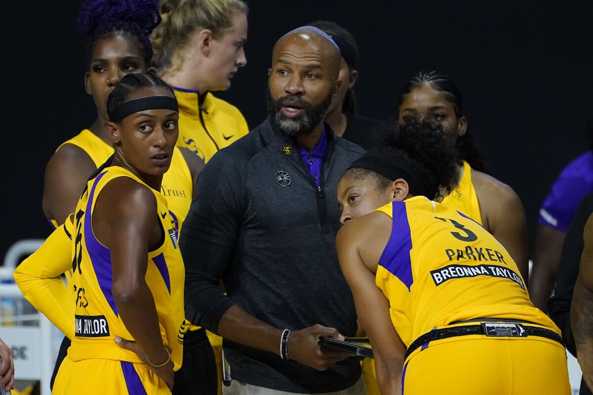 Sparks head coach Derek Fisher talks to guard Brittney Sykes and forward Candace Parker.