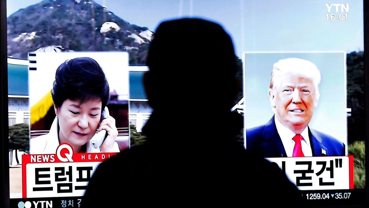 At the Seoul Railway Station, a man watches a report about South Korean President Park Geun-hye and U.S. President-elect Donald Trump on Nov. 10, 2016.