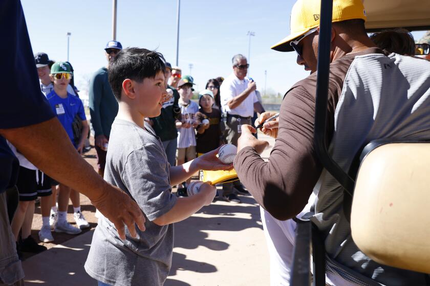 PEORIA, AZ - February 20: Padres' Manny Machado signs a autograph during a spring training practice on February 20, 2024. (K.C. Alfred / The San Diego Union-Tribune)