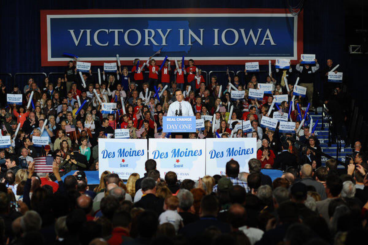 Supporters of Mitt Romney cheer during a rally in Des Moines.
