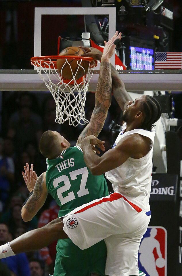Clippers forward Kawhi Leonard dunks on Celtics forward Daniel Theis during a game Nov. 20 at Staples Center.