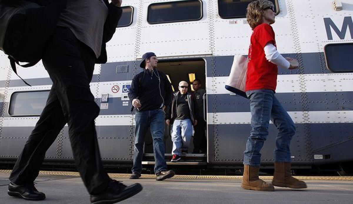 Rail passengers arrive at the Angels Stadium Metrolink station in Anaheim.