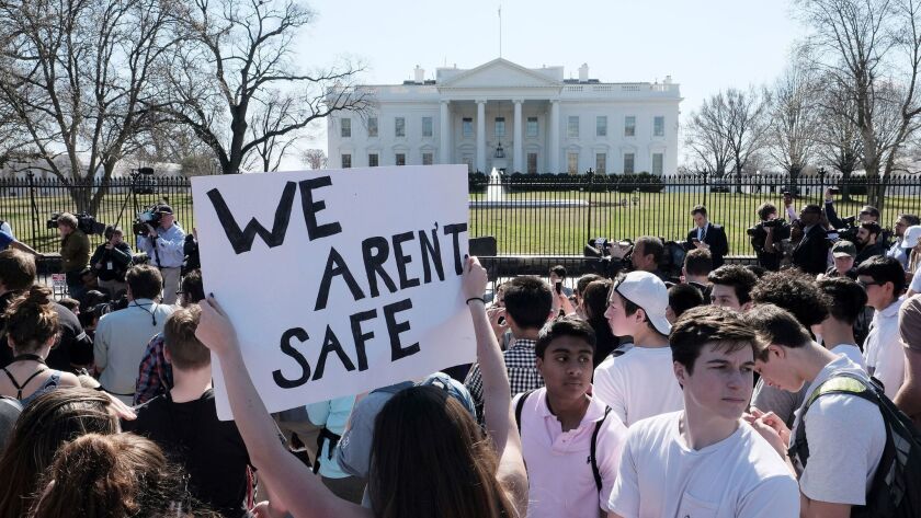 High school students gather in front of the White House on Wednesday to rally against gun violence. Inside the White House, President Trump held a listening session with students, parents and teachers about the topic.