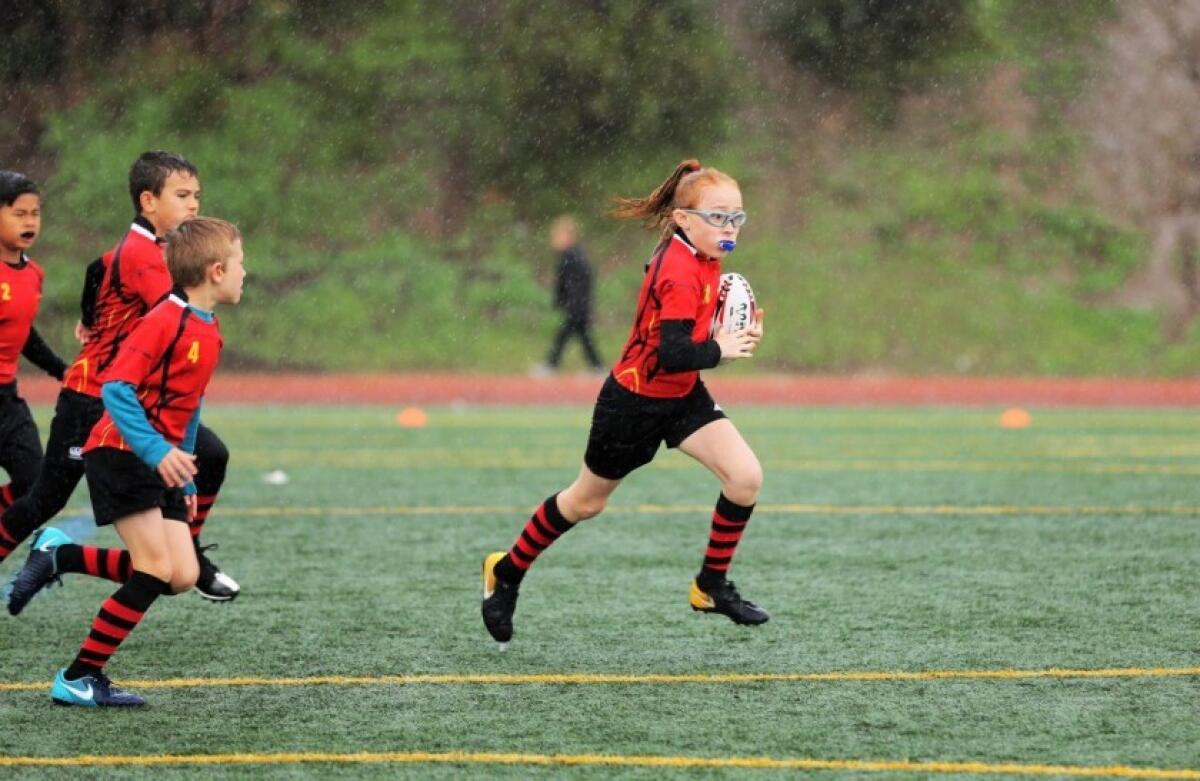 Rugby players in action on the field.