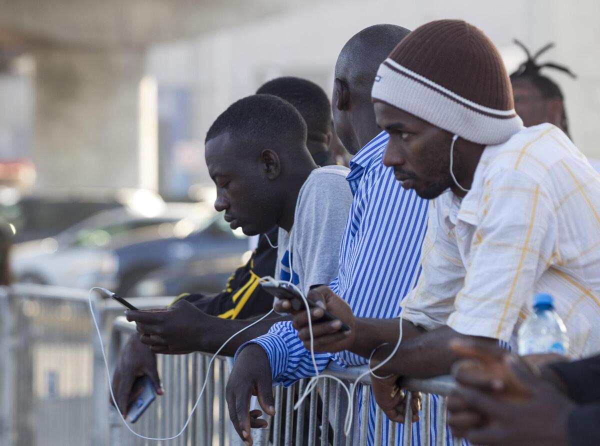 Immigrants waited along the barriers at the El Chaparral port of entry to see if their number would be called so they could be taken to the U.S. for their interviews on Sept. 13, 2019, in Tijuana.