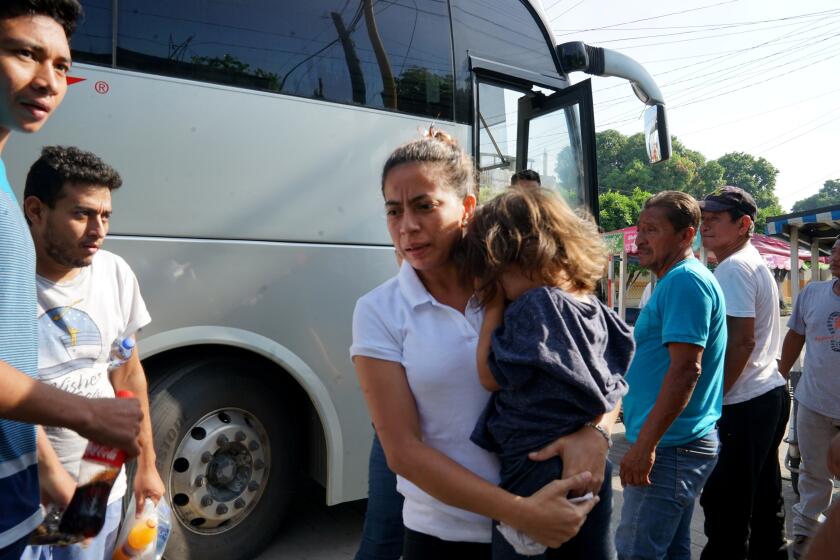 Central American migrants sent back by U.S. to Matamoros on northern border emerge from Mexican government-paid buses in Ciudad Hidalgo, Mexico, at the southern border with Guatemala.