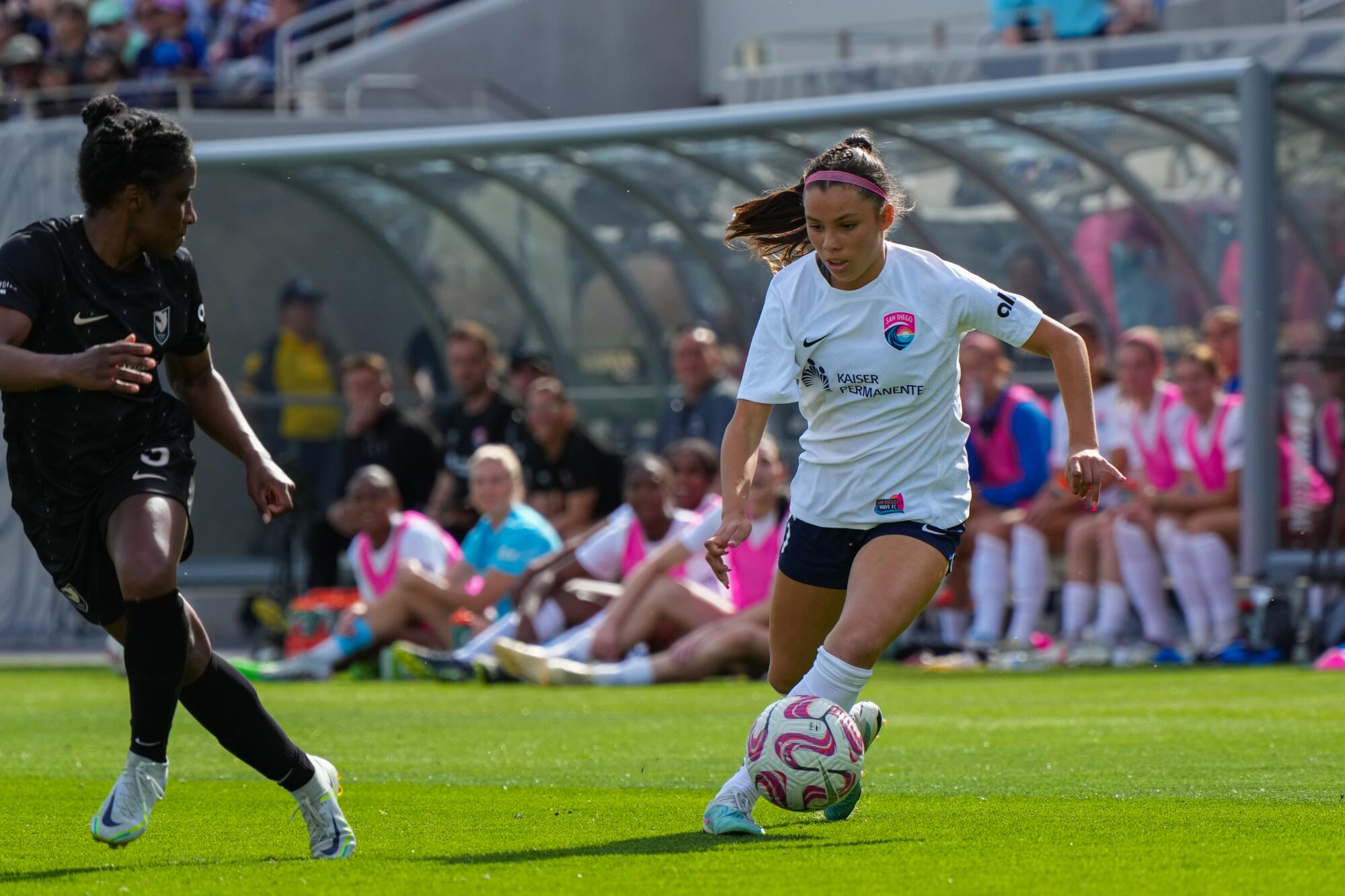 Two women playing soccer