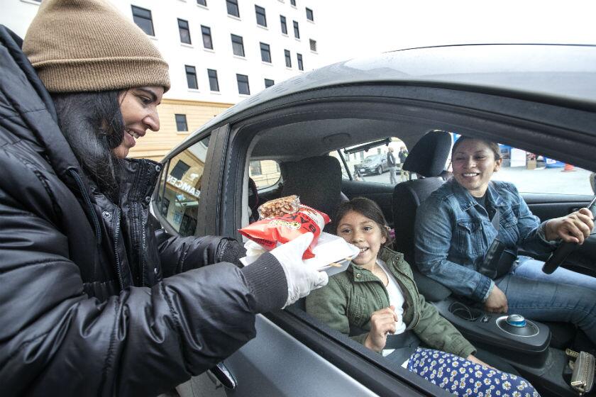 Volunteer Rachel Figueroa serves free lunch in Los Angeles.